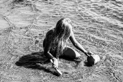 Girl sitting on beach at sea shore