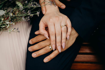 Midsection of couple holding hands