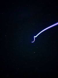 Low angle view of star trails in sky