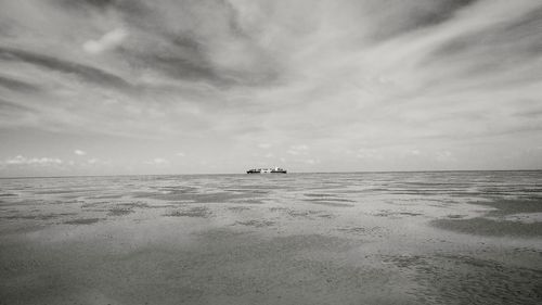 Distance shot of boat in calm sea against sky