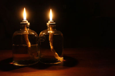 Close-up of illuminated candles on table