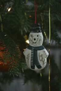 Close-up of christmas decoration hanging on tree at night
