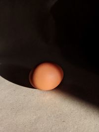 High angle view of orange eggs against black background