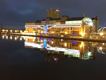 Reflection of buildings in city at night