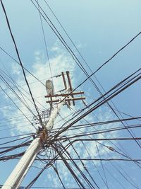 Low angle view of power lines against sky