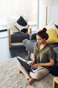 Woman sitting on table at home