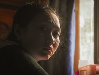 Close-up of young woman looking away