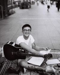 Portrait of smiling man playing guitar