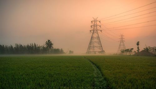 Scenic view of field against sky during sunset