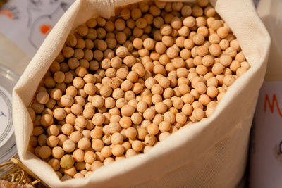 Canvas bag with soybeans. the concept of harvesting soybeans in agriculture