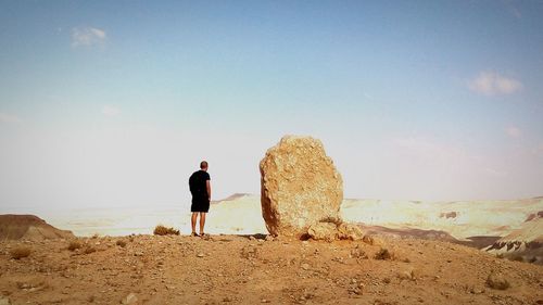 Rear view of woman standing on landscape