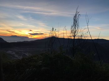 Silhouette landscape against sky during sunset