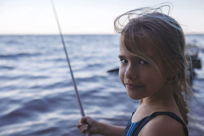 Portrait of woman against sea