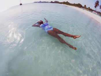 High angle view of woman swimming in sea