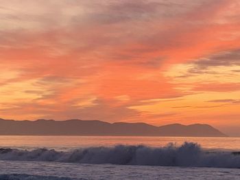 Scenic view of sea against orange sky