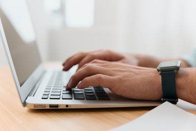 Midsection of woman using laptop