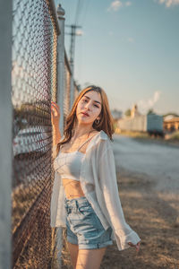 Full length of woman standing against sky