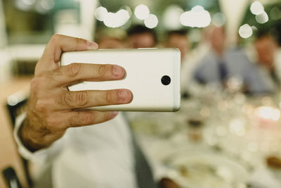 Close-up of man holding mobile phone
