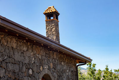 Low angle view of old building against blue sky