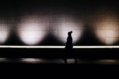Silhouette man standing in corridor