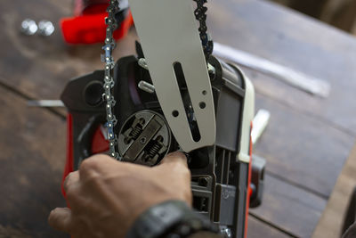 Cropped hand of man repairing car