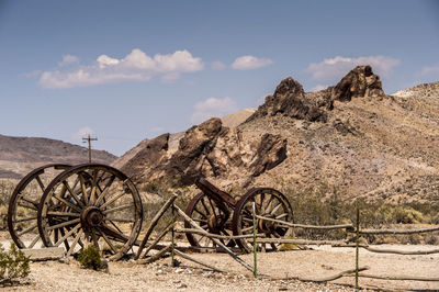 Old carts by hill in ghost town