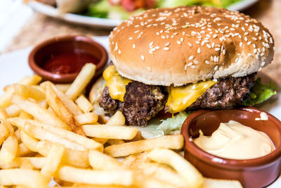 Close-up of burger with french fries and dip