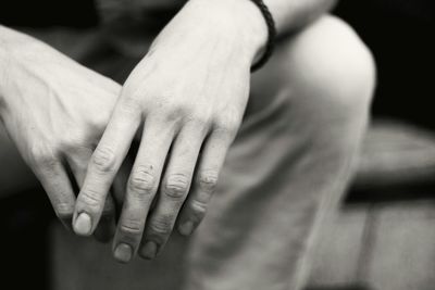 Close-up of clasped hands of young man