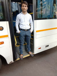 Portrait of man standing in bus