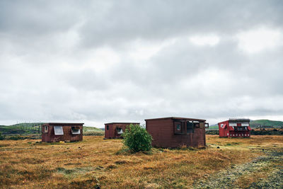 Small houses on deserted field at countryside