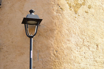 Low angle view of street light on wall