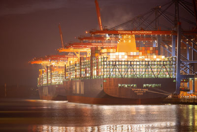 Illuminated pier at harbor