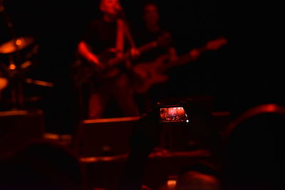 Close-up of hand holding illuminated lighting equipment