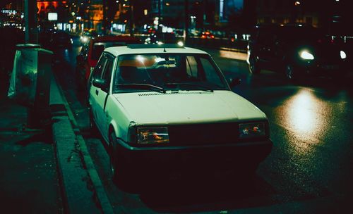 Cars on city street at night