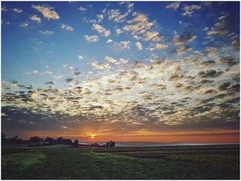 Scenic view of field against sky during sunset