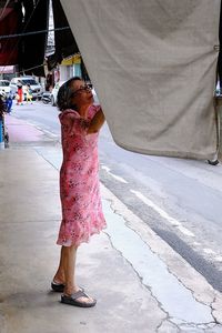 Full length of woman standing on street