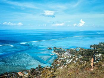 Aerial view of sea against blue sky