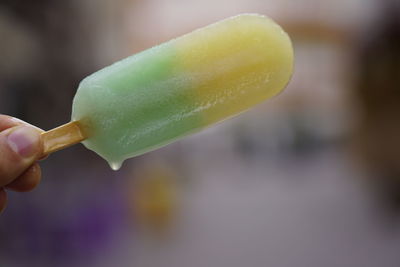 Close-up of hand holding ice cream cone