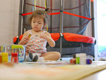 Cute girl sitting on table