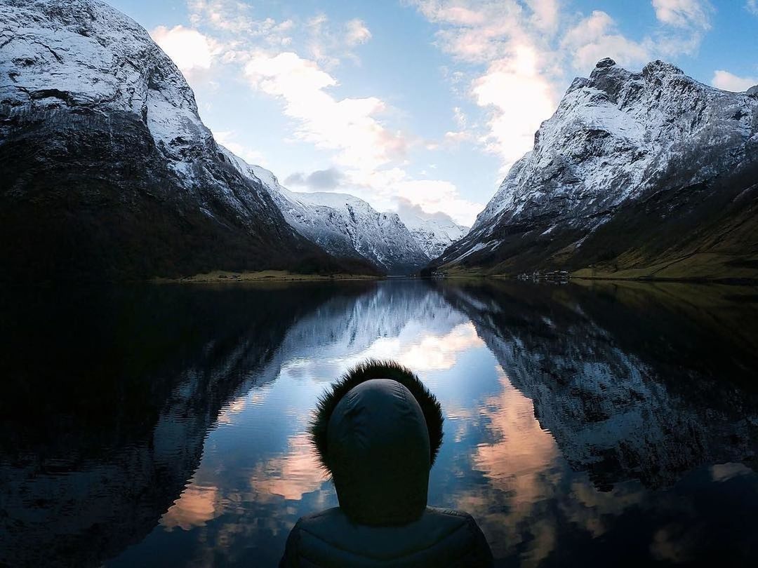 water, reflection, scenics - nature, mountain, beauty in nature, sky, non-urban scene, tranquil scene, tranquility, cloud - sky, lake, mountain range, nature, winter, cold temperature, one person, idyllic, rear view, day, snowcapped mountain