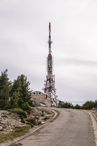 Hikers, antennas and buildings at the top of the cardó mountain range.