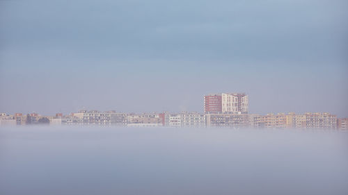 Buildings in city against clear sky