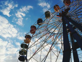 Low angle view of ferris wheel against sky