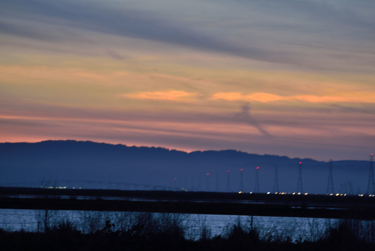 SCENIC VIEW OF LAKE AGAINST SKY AT SUNSET