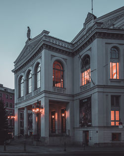 Low angle view of illuminated building against sky