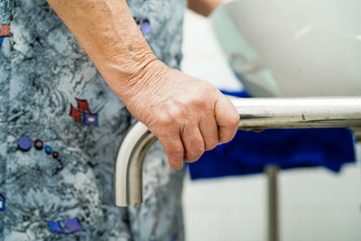 Cropped hand of person washing hands