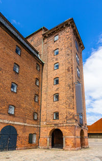 Low angle view of old building against blue sky