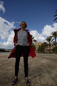 Full length of woman standing against sky