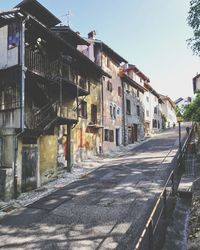 Street amidst buildings in city against sky