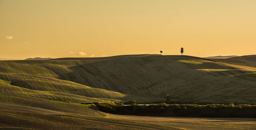 Scenic view of landscape against sky during sunset